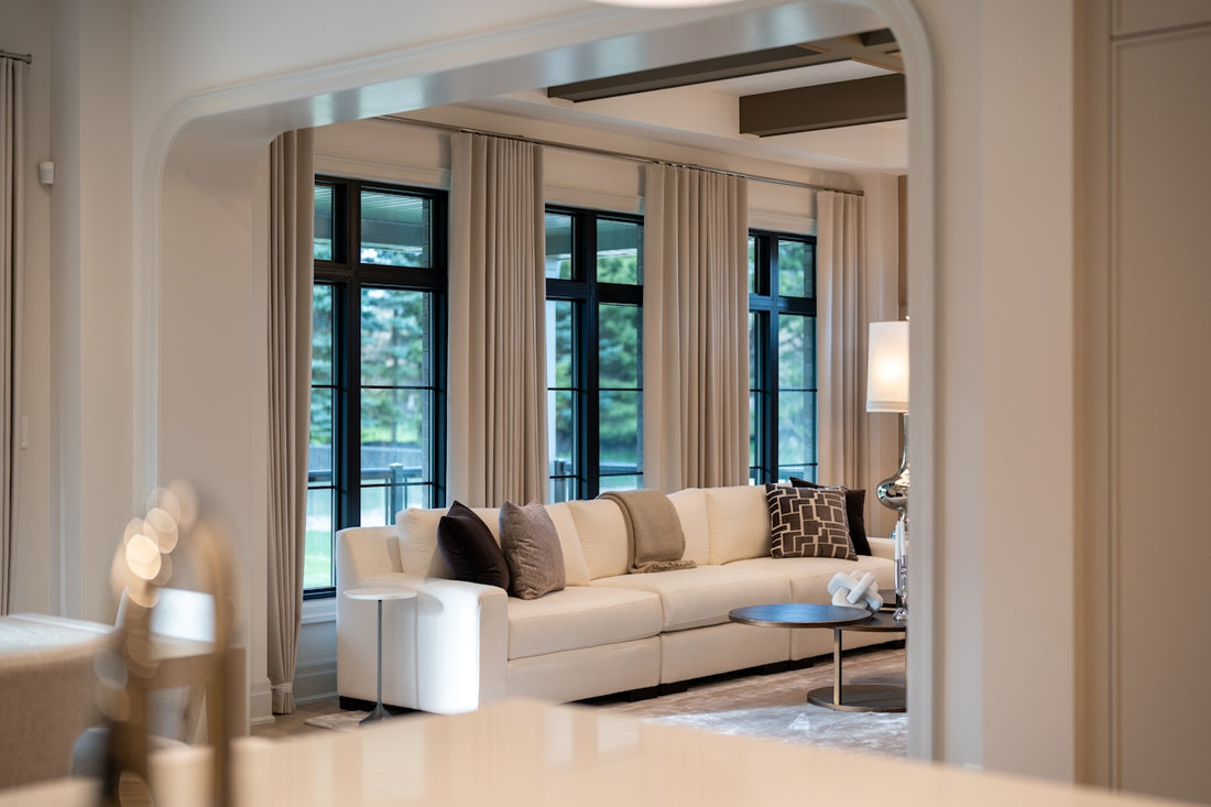 Elegant living room with large sofa and windows