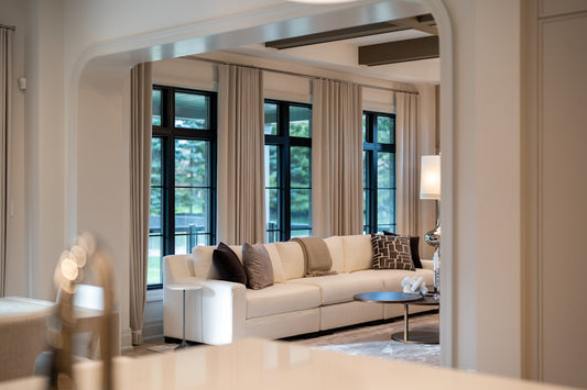 Elegant living room with large sofa and windows